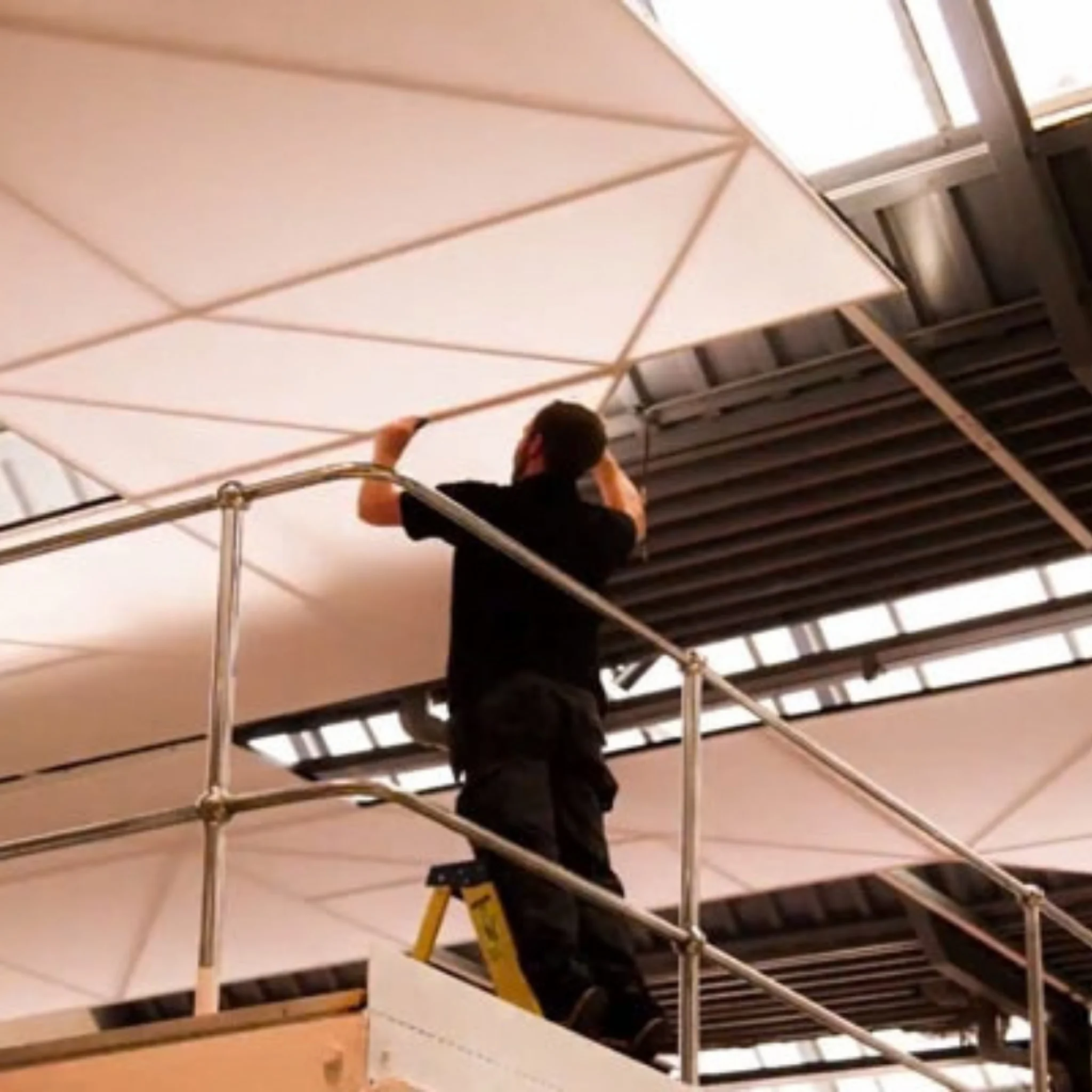 Floating acoustic cloud ceiling panel installation in office lobby